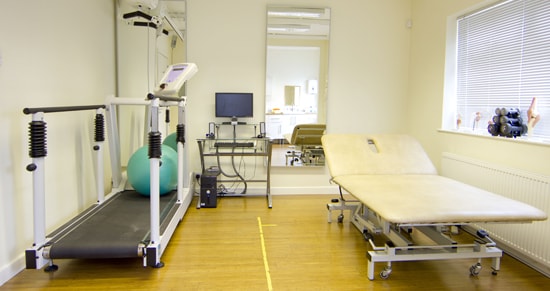 Interior shot of Manchester OT clinic with treadmill and patient beds.